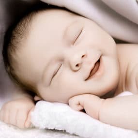 happy baby sleeping smile close up studio portrait warrington