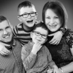 photograph mum dad and their two boys in black and white. Taken at Bartley Studios Manchester Warrington