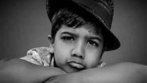 character portrait young boy wearing a hat in black and white knutsford