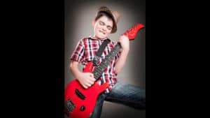 young boy with electric guitar portrait of kid