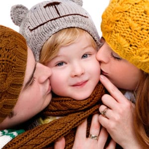 winter studio shoot parents kissing child manchester studio portrait