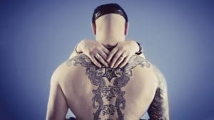 Couple portrait with tattoo on back showing style and love cap taken at Bartley Portraits Chester Warrington