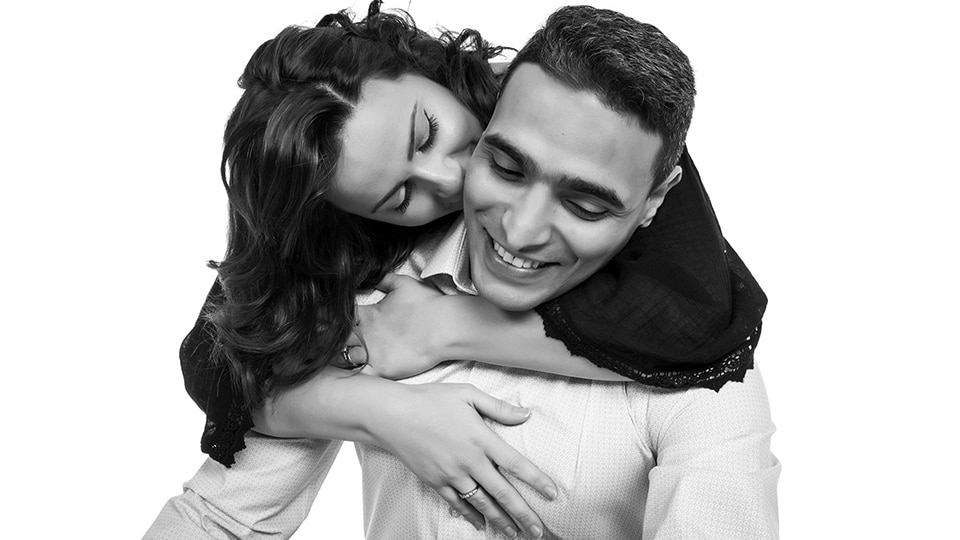 Beautiful portrait of a couple with lady behind male arms wrapped around him b&w venture portraits liverpool chester stockport rochdale