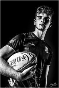 teenager with rugby ball in photo studio