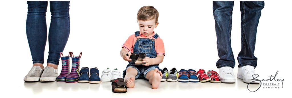 boy sat in photography studio with shoes
