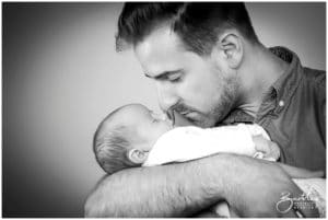 proud daddy holding newborn baby