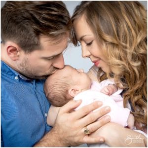 couple holding newborn baby in photo studio warrington