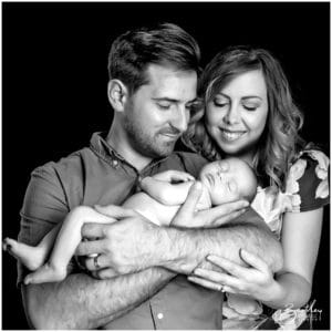 couple holding newborn baby in photo studio warrington