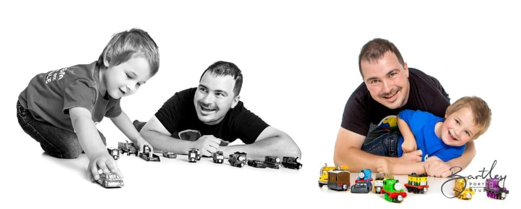 little boy playing with model cars in a photography studio