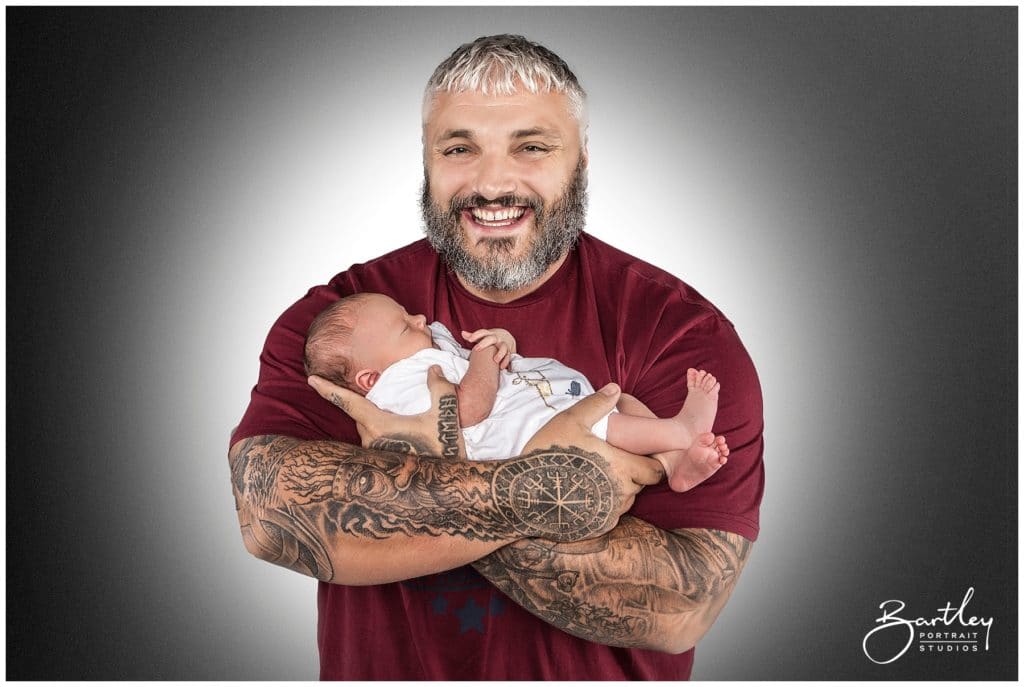 proud dad holding baby