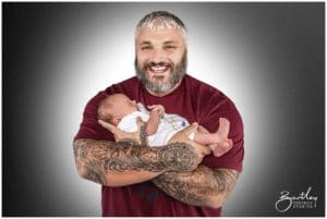 proud dad holding baby