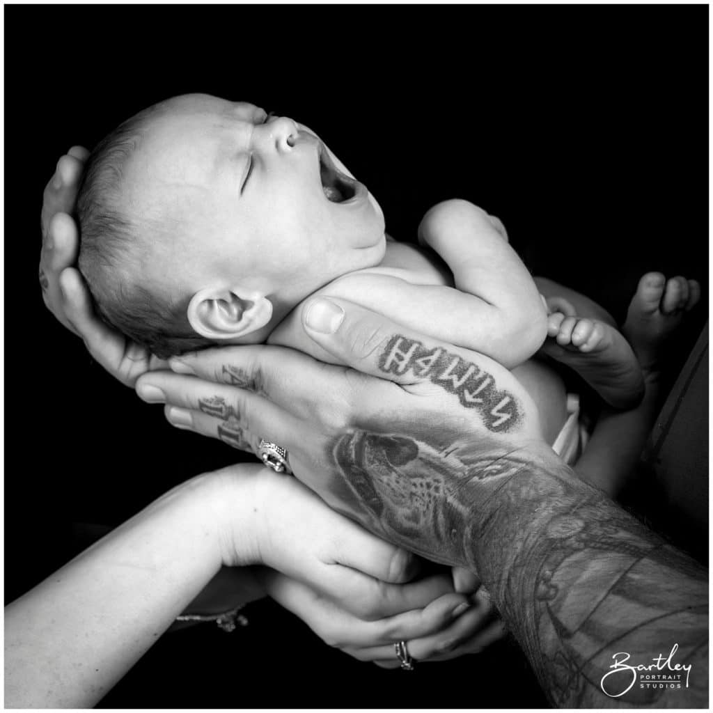 hands holding newborn baby