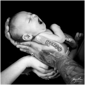 hands holding newborn baby