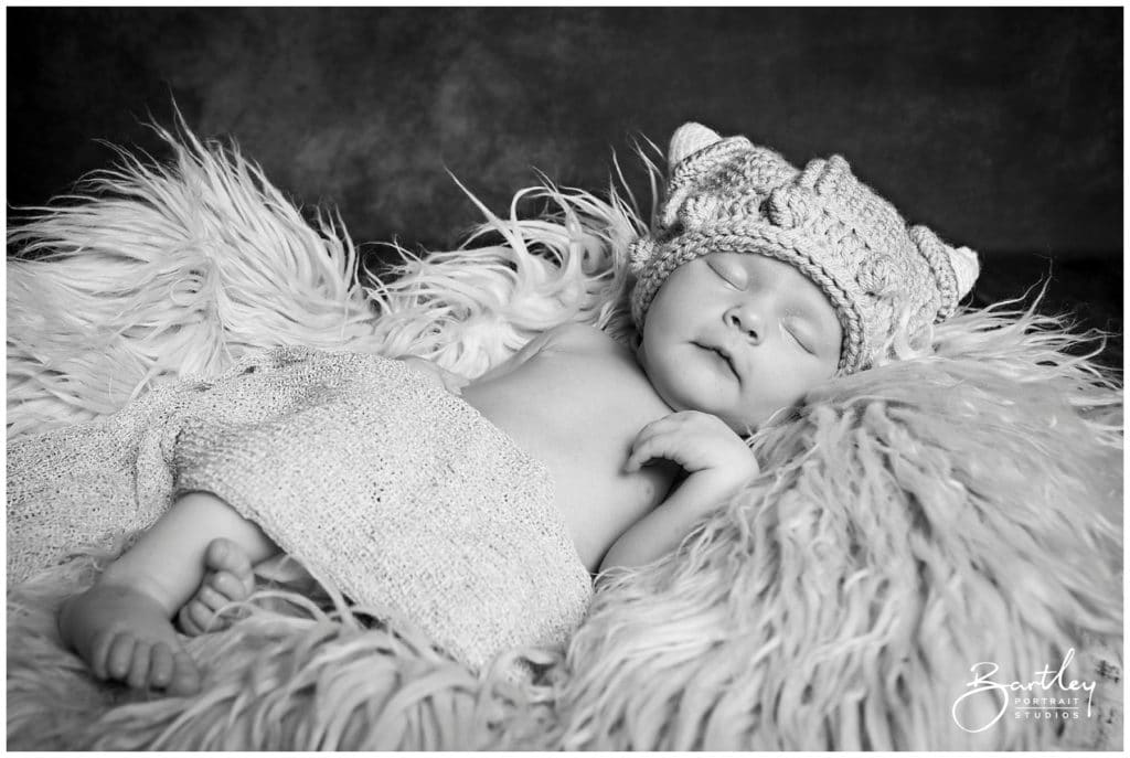 baby in viking knitted helmet asleep