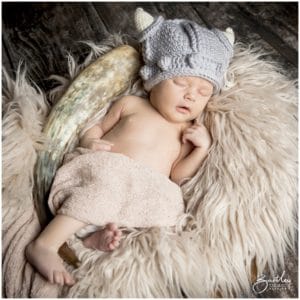 baby in viking knitted helmet asleep