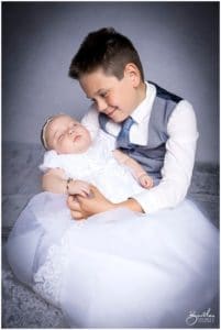 christening outfit baby portrait with brother