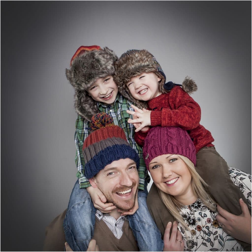 kids portrait on parents shoulders